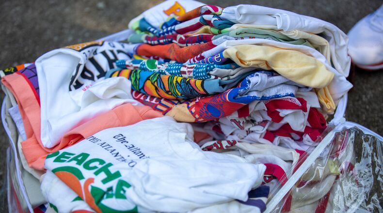 Long-time runner Bill Thorn's collection of T-shirts from the Peachtree Road Race in Tyrone, Georgia, on Tuesday, October 13, 2020. Bill Thorn was presented the T-shirt for the annual Peachtree Road Race on Tuesday by the Atlanta Track Club. (Photo/Rebecca Wright for the Atlanta Journal-Constitution)