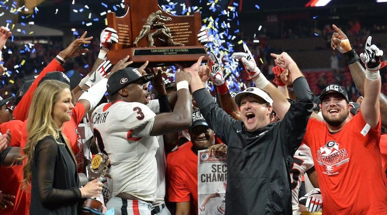 December 2, 2017 Atlanta: Georgia Bulldogs linebacker Roquan Smith (3), head coach Kirby Smart, and Georgia teammates celebrate after defeating the Auburn Tigers 28-7 during the Southeastern Conference championship NCAA college football game at Mercedes-Benz Stadium, December 2, 2017, in Atlanta. Hyosub Shin / hshin@ajc.com