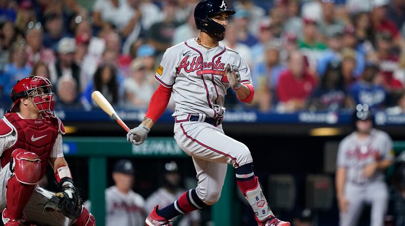 Atlanta Braves' Eddie Rosario follows through after hitting a run-scoring single against Philadelphia Phillies pitcher Craig Kimbrel during the 10th inning of a baseball game, Tuesday, Sept. 12, 2023, in Philadelphia. (AP Photo/Matt Slocum)