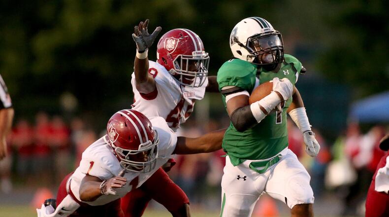 August 21, 2015 - Roswell, Ga: Roswell running back Sheldon Evans (1) gets past Lowndes linebacker Mike Barrett (1, left) and linebacker Roderick Williams (49) for a 37-yard touchdown run in the second quarter of their game Friday at Roswell High School in Roswell, Ga., August 21, 2014. Tonight is the first game of the season for both Roswell and Lowndes. PHOTO / JASON GETZ