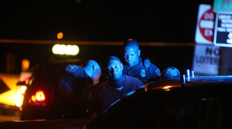 Officers interviewed the second inmate who was being escorted by a second detective when the shooting broke out and then took him away in a police car on Oct. 2, 2014.