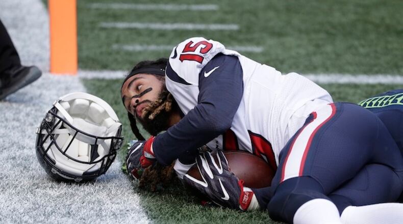 Houston Texans wide receiver Will Fuller loses his helmet after a reception for a touchdown against the Seattle Seahawks in the first half of an NFL football game, Sunday, Oct. 29, 2017, in Seattle. (AP Photo/Elaine Thompson)