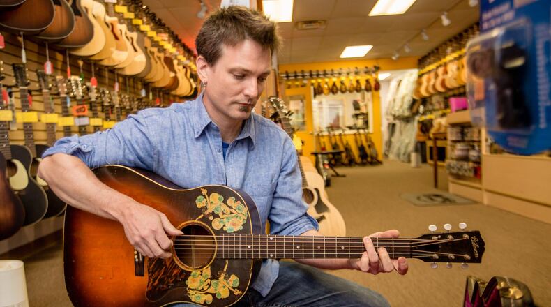 Maple Street Guitars in Buckhead is a mainstay for guitar lessons, all their teachers continue to provide lessons online and classes are available for new students to join Tuesday, April 14, 2020. Lindsay Petsch, the store manager, is still coordinating lessons, taking repairs and is providing strings and other guitar accessories for sale outside in front of the store. (Jenni Girtman/ Atlanta Journal-Constitution)