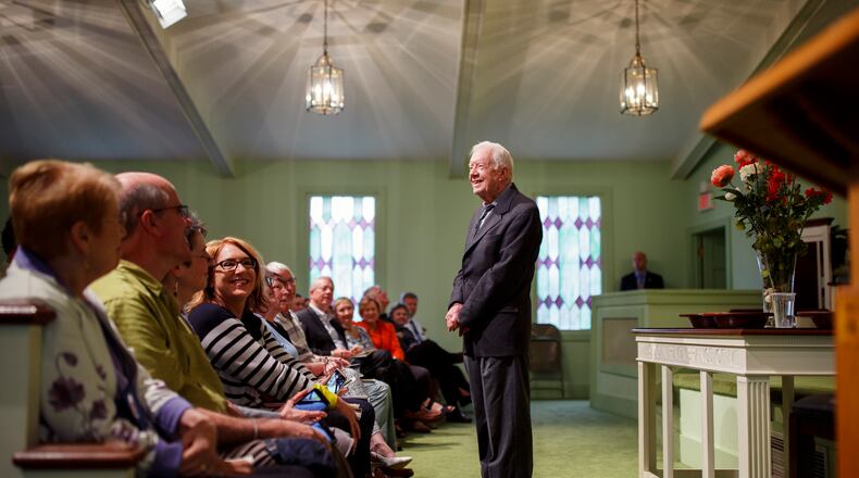 Former President Jimmy Carter greets visitors before teaching a Sunday school class at Maranatha Baptist Church in Plains in April 2018. The former president, now 99, has been in hospice care since February 2023. “He is just the same remarkable man," said Paige Alexander, CEO of the Carter Center. "He has always been outliving and surprising us all.” (Melissa Golden/The New York Times)