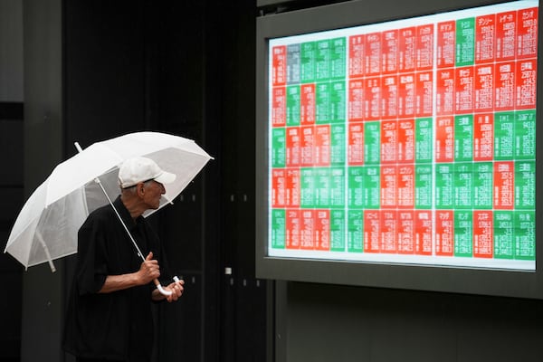 A person looks at an electronic stock board showing Japan's Nikkei index at a securities firm Wednesday, June 25, 2025, in Tokyo. (AP Photo/Eugene Hoshiko)