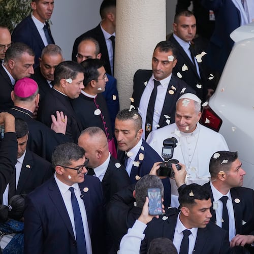 Rose petals are scattered to Pope Leo XIV as he leaves after visiting the Psychiatric Hospital of the Cross in the town of Jal el-Dib, north of Beirut, Lebanon, Tuesday, Dec. 2, 2025. (AP Photo/Hassan Ammar)