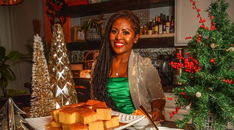 Chef Razia Sabour, the winner of “The Great Soul Food Cook-Off” on Discovery+, knows how crucial the sides are to her holiday spread. Here, she's shown with her Skillet Honey Cornbread, Sweet Potato Soufflé (front left) and Baked Macaroni and Cheese (front right). (Styling by Razia Sabour / Chris Hunt for the AJC)