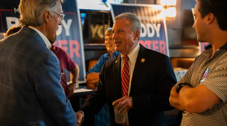 Buddy Carter greets supporters while watching primary results roll in during his watch party in Sandy Springs last month. (Olivia Bowdoin for the AJC)