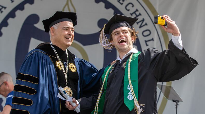 William Willis takes a photograph with Georgia Tech President Ángel Cabrera after receiving his diploma during the Georgia Institute of Technology's afternoon Commencement Ceremony at Bobby Dodd Stadium Saturday, May 7, 2022. (Steve Schaefer / steve.schaefer@ajc.com)