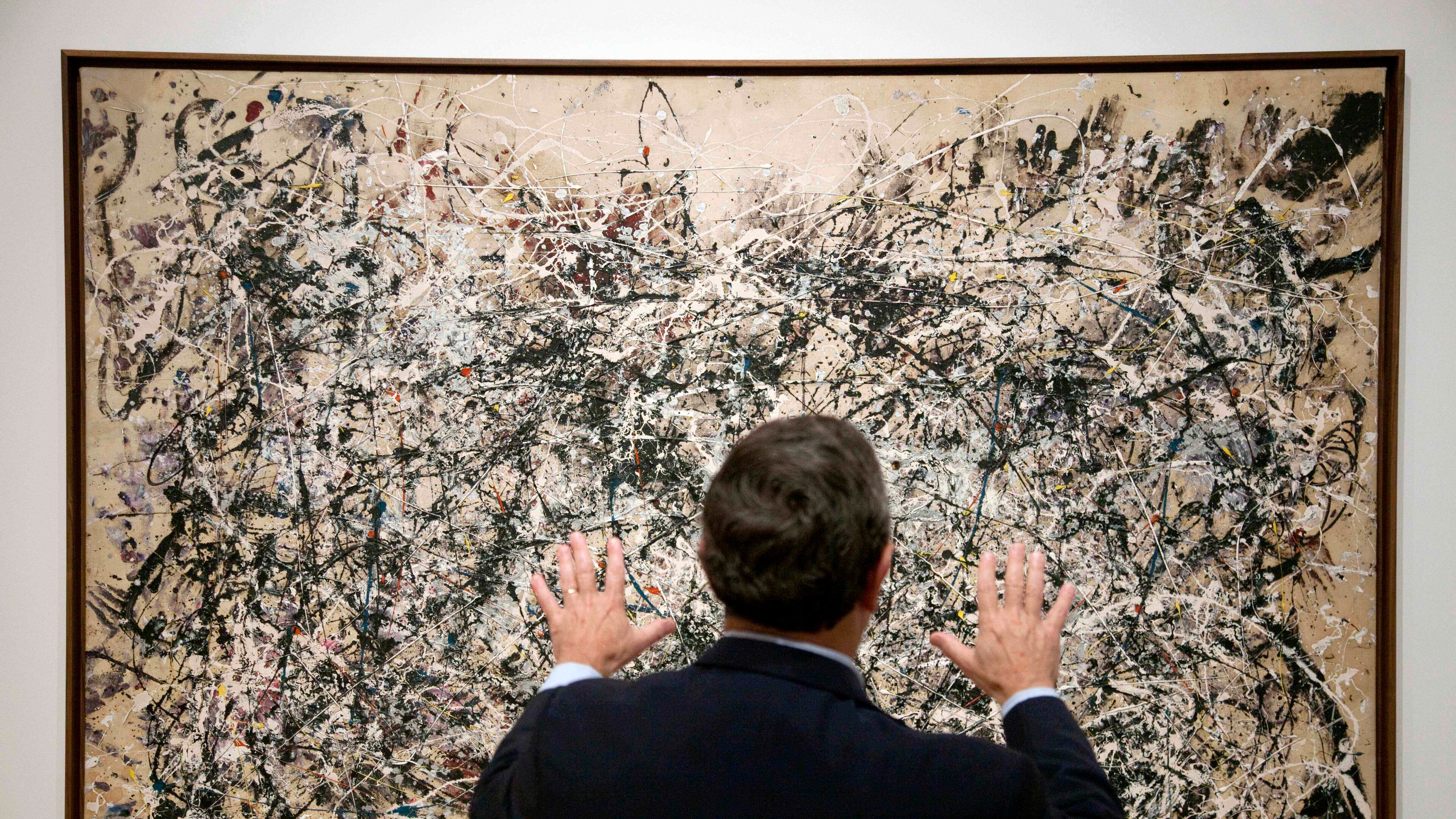 FILE - David Brenneman, director of collections and exhibitions at the High Museum, talks about Jackson Pollock's painting "Number 1A" on display as part of an exhibit in Atlanta, on Thursday, Oct. 6, 2011. (AP Photo/David Goldman, File)