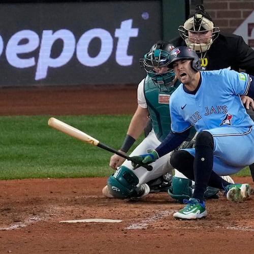 Toronto Blue Jays' George Springer falls after being hit by a pitch against the Seattle Mariners during the seventh inning in Game 5 of baseball's American League Championship Series, Friday, Oct. 17, 2025, in Seattle. (AP Photo/David J. Phillip)