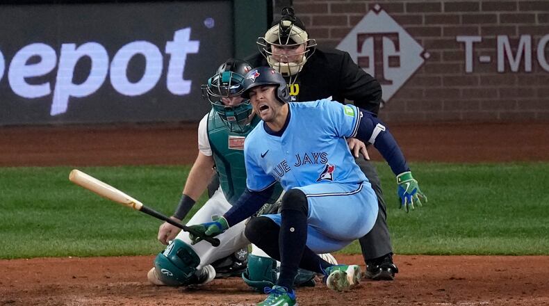 Toronto Blue Jays' George Springer falls after being hit by a pitch against the Seattle Mariners during the seventh inning in Game 5 of baseball's American League Championship Series, Friday, Oct. 17, 2025, in Seattle. (AP Photo/David J. Phillip)