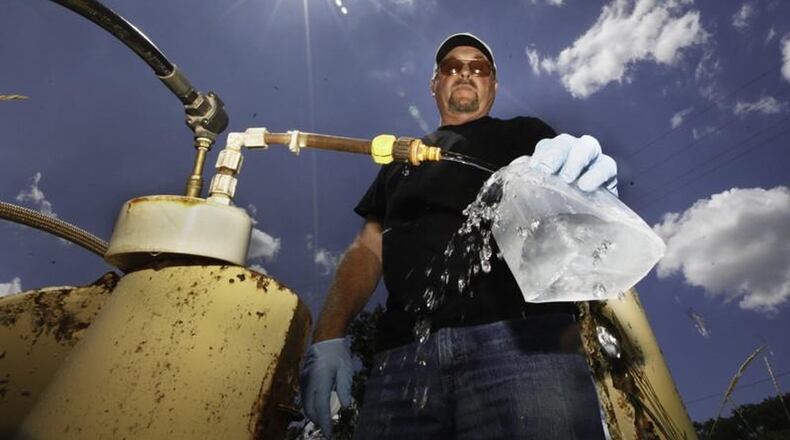 Dan Day, a water lab technician with the City of Dayton, takes a sample from one of 200 monitoring wells used to check on the quality of water in the Great Miami Buried Valley Aquifer and test for any contaminants on a regular basis. CHRIS STEWART / STAFF