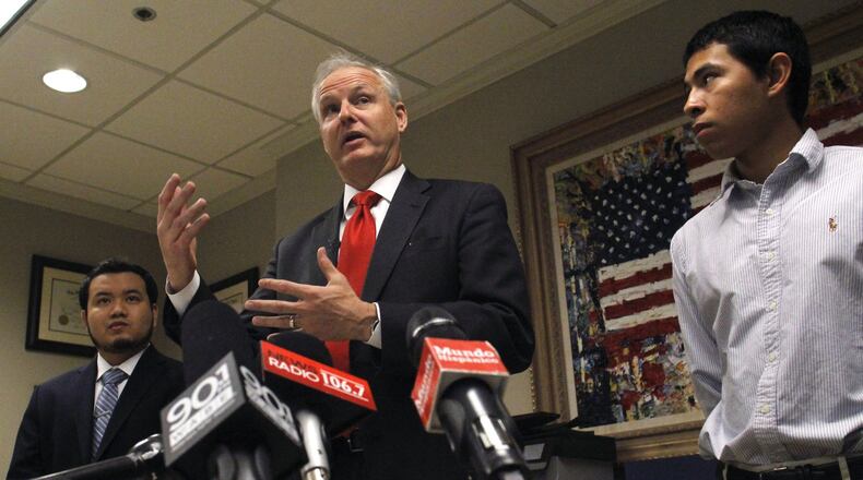 February 1, 2016 Atlanta - Attorney Charles Kuck, center, and two plaintiffs, Rigoberto Rivera, left, and Ivan Morales, discuss their legal case for allowing Deferred Action for Childhood Arrivals recipients to pay in-state tuition in Georgia. TAYLOR CARPENTER / TAYLOR.CARPENTER@AJC.COM