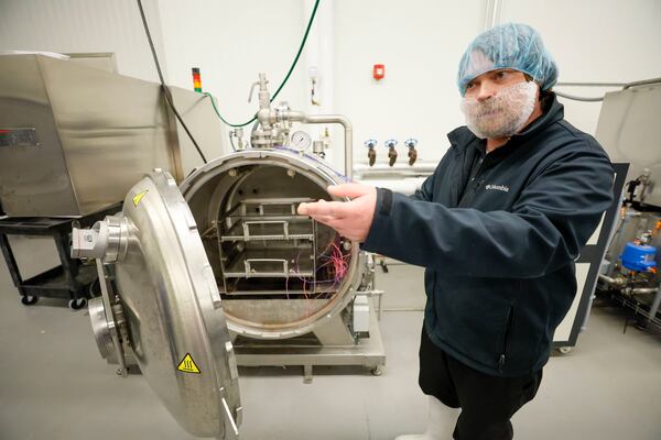 Michael Aaron, quality system manager at the Food Product Innovation Center at the University of Georgia Griffin campus, demonstrates one of machines they use to develop food products.
(Miguel Martinez/ AJC)