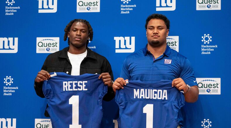 New York Giants' first round draft pick Arvell Reese, left, and Francis Mauigoa, right, pose for a picture during an NFL football press conference at the team's training facility, Friday, April 24, 2026, in East Rutherford, N.J. (AP Photo/Yuki Iwamura)