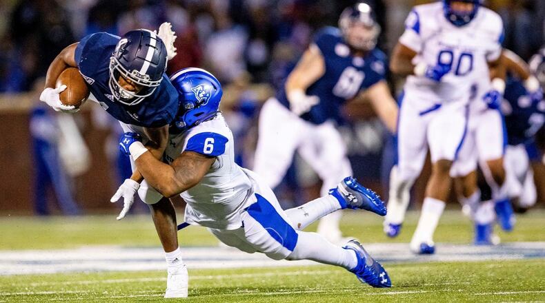 Georgia Southern receiver Khaleb Hood completes a pass for a huge gain but gets stopped by Georgia State defender Trajan Stephens-McQueen (6) Saturday, Nov. 30, 2019, in Statesboro, Ga.