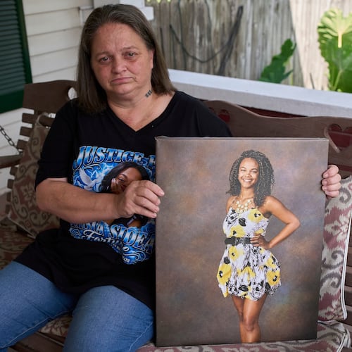 Christy Spivey poses with a portrait of her late daughter Tasia Fortune, Tuesday, Sept. 8, 2026, in Marion, Ky. (AP Photo/George Walker IV)