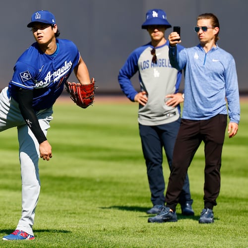 Los Angeles Dodgers' Shohei Ohtani, left, throws in the outfield before the second game of a baseball doubleheader against the New York Yankees, Sunday, July 19, 2026, in New York. (AP Photo/Noah K. Murray)
