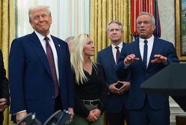President Donald Trump (from left) and Rep. Marjorie Taylor Greene look on as Robert F. Kennedy Jr. speaks after being sworn in as secretary of Health and Human Services on Thursday, Feb. 13, 2025, in Washington, D.C. (Andrew Caballero-Reynolds/AFP via Getty Images/TNS)