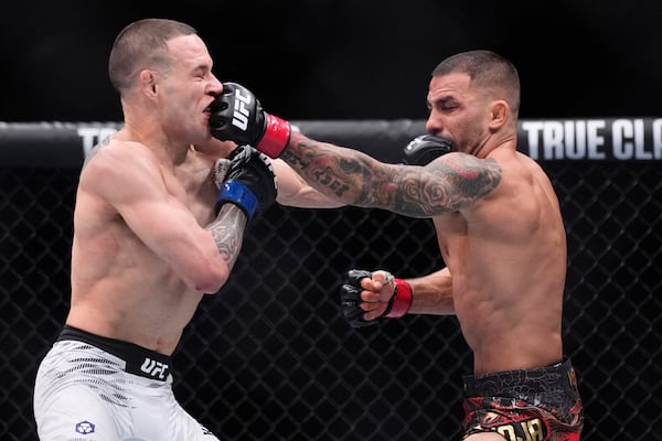 Alexandre Pantoja, right, and Kai Kara-France exchange blows in a flyweight title fight at UFC 317, Saturday, June 28, 2025, in Las Vegas. (AP Photo/John Locher)