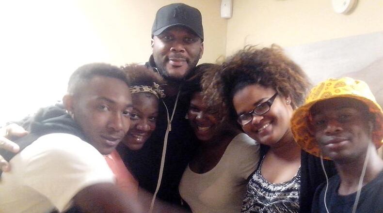 Tyler Perry with clients of Young People Matter.