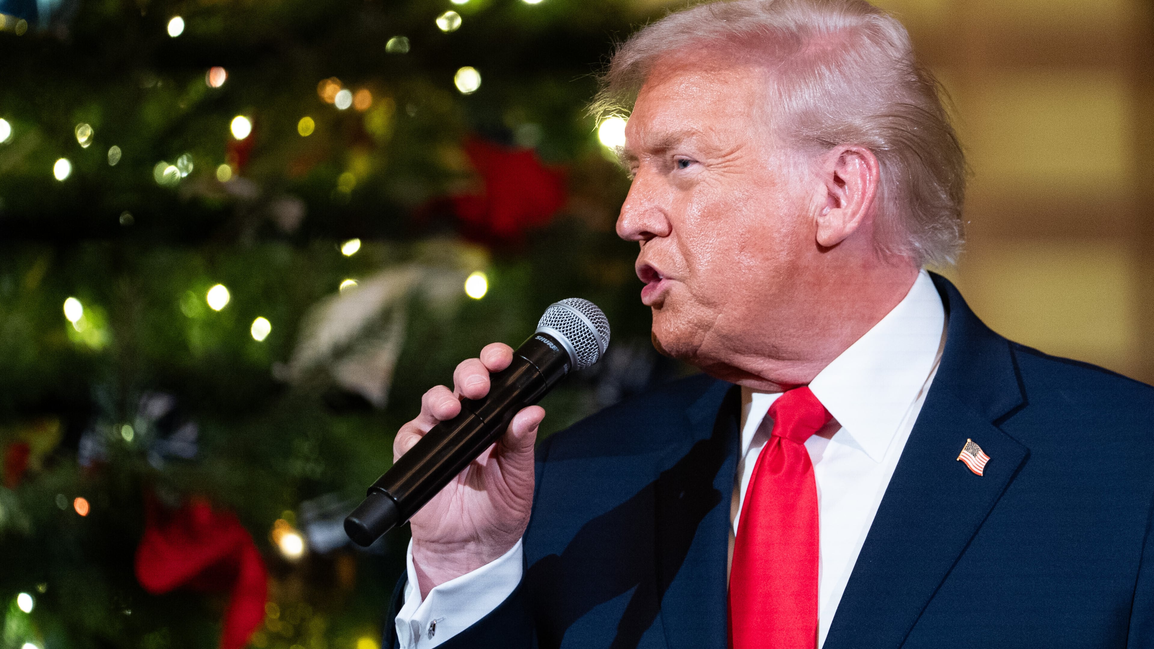 President Donald Trump speaks before a concert by Andrea Bocelli in the East Room of the White House walking towards the East Room, Friday, Dec. 5, 2025, in Washington. (AP Photo/Allison Robbert)