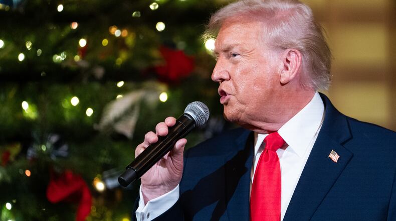 President Donald Trump speaks before a concert by Andrea Bocelli in the East Room of the White House walking towards the East Room, Friday, Dec. 5, 2025, in Washington. (AP Photo/Allison Robbert)