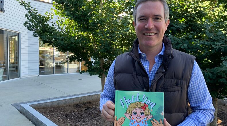 Craig Lucie, the former WSB-TV anchor, is now in public relations but also decided to write a children's book "Hold You." RODNEY HO/rho@ajc.com
