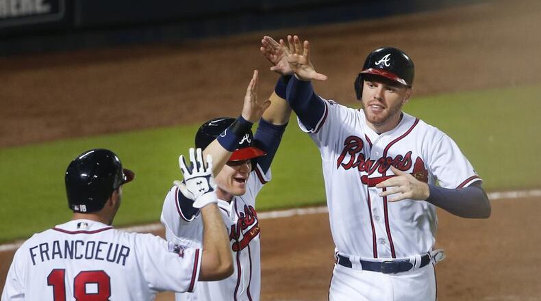 John BazemoreAtlanta Braves' Gordon Beckham (7) and Freddie Freeman, right, celebrate after scoring on a Nick Markakis base hit in the eighth inning of a baseball game against the Miami Marlins, Friday, May 27, 2016, in Atlanta. Atlanta won 4-2. (AP Photo/John Bazemore)