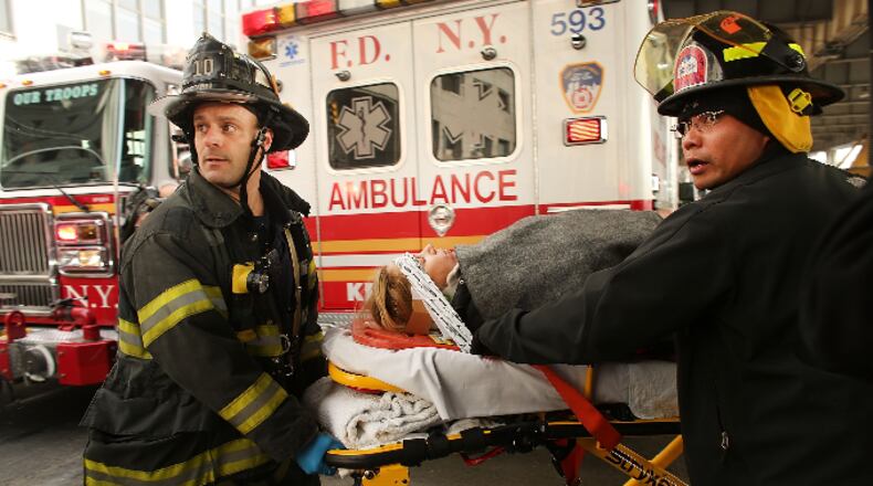 An injured person is carried to a waiting ambulance following an early morning ferry accident during rush hour in Lower Manhattan on January 9, 2013 in New York City.