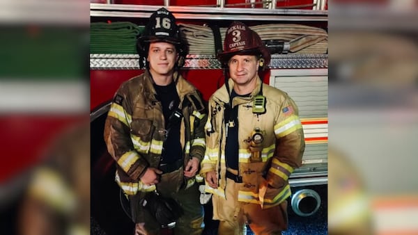 Jake Holcomb (left) and his father, Battalion Chief Patrick Holcomb, have gotten to fight some fires together for the DeKalb County Fire Department. (Courtesy of Holcomb family)