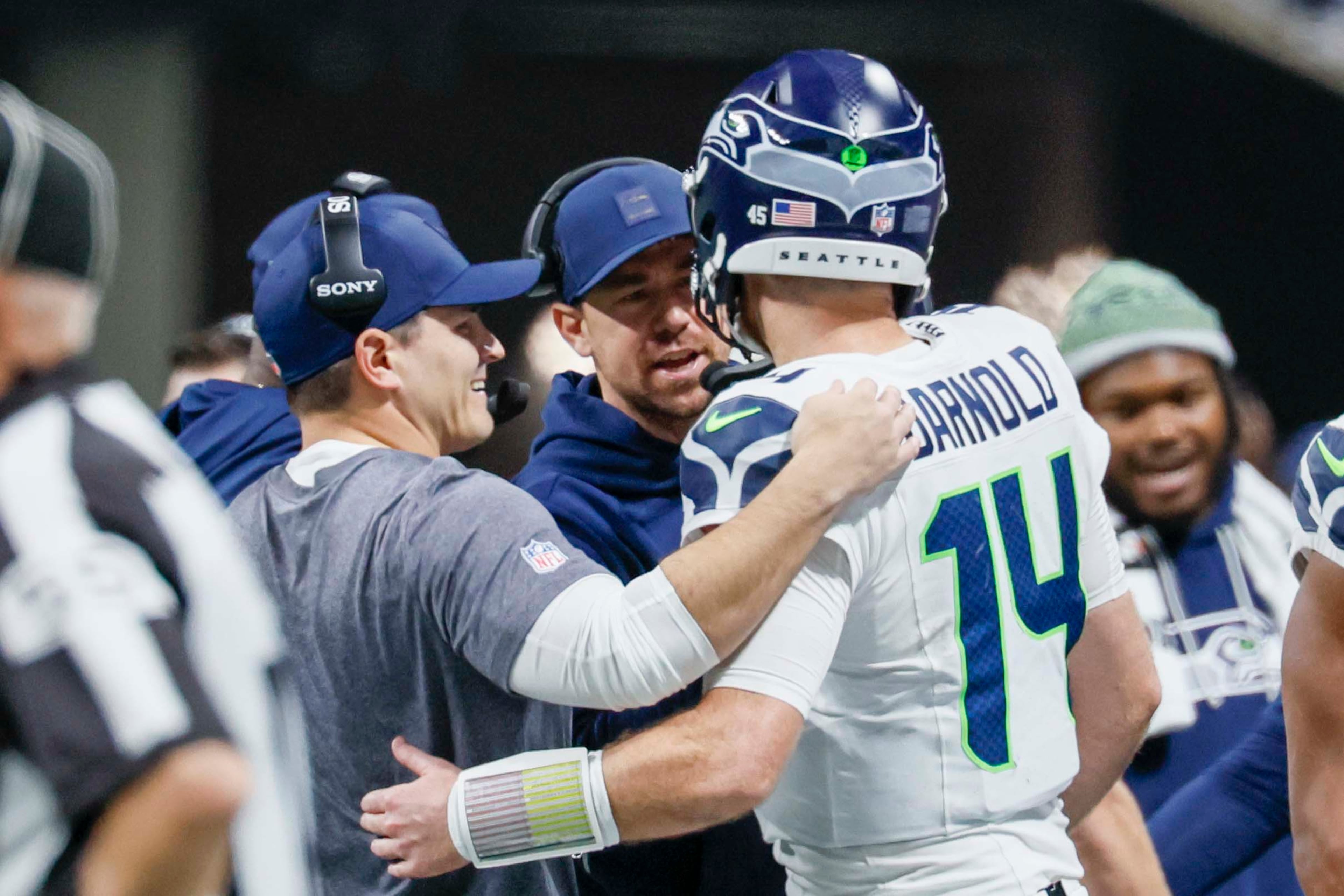 Seattle Seahawks head coach Mike MacDonald congratulates Seahawks quarterback Sam Darnold (14) after a touchdown during the second half of an NFL game against the Falcons at Mercedes-Benz Stadium in Atlanta on Sunday, Dec. 7, 2025.
(Miguel Martinez/ AJC)