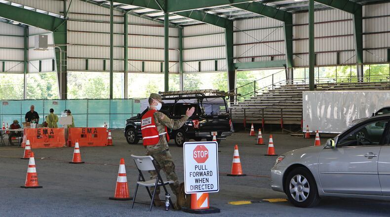 Kyle Potts, of the 170th Military Police Battalion, directs cars at the Cobb County CO-VID 19 testing site at Jim R. Miller Park in Marietta, Georgia, on Friday, April 17, 2020. The site has expanded its hours and no longer requires a doctorâs referral to be tested for the virus. (Christina Matacotta, for The Atlanta Journal-Constitution)