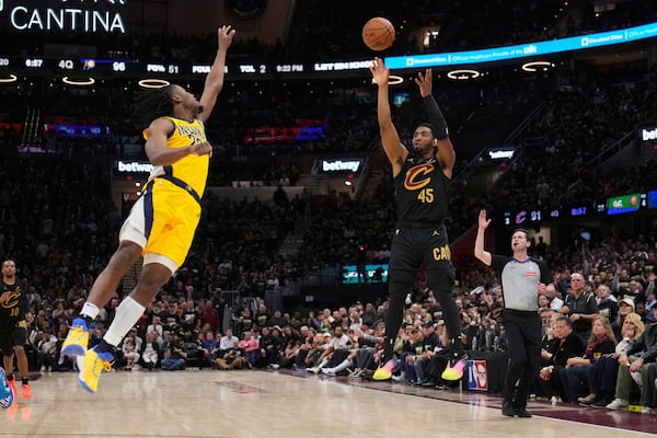 Cleveland Cavaliers guard Donovan Mitchell, right, shoots as Indiana Pacers forward Aaron Nesmith defends during the second half in Game 5 of an Eastern Conference semifinal NBA basketball playoff Tuesday, May 13, 2025, in Cleveland. (AP Photo/Sue Ogrocki)