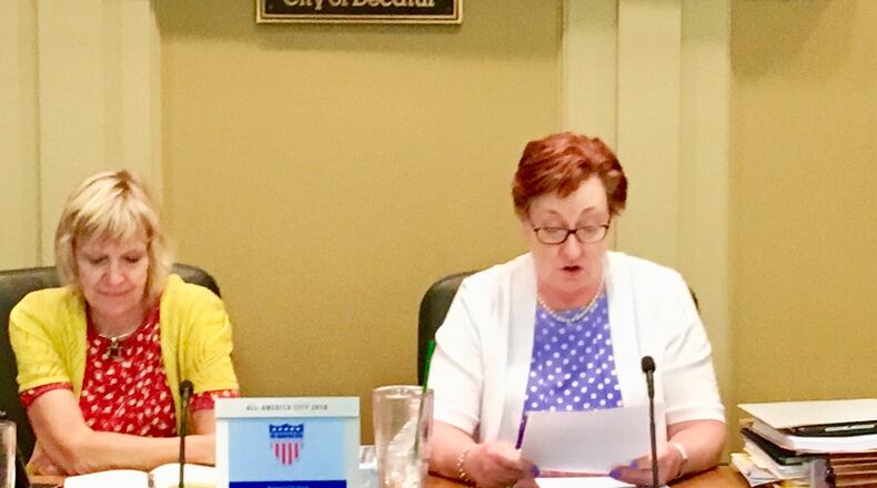 Decatur City Manager Peggy Merriss reads the announcement of her surprising resignation Monday night. To her right is Mayor Patti Garrett. Bill Banks for the AJC