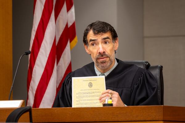 Superior Court Judge Robert McBurney holds an order suspending an execution at a hearing at the Fulton County Courthouse in Atlanta on Monday. (Arvin Temkar/AJC)