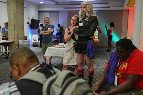 Marion F., left, and her partner Jessie G., embrace as they listen to speakers during a pre-rally with the National Trans Visibility March, held at the Human Rights Campaign, before marching to join the World Pride Rally on the National Mall, Sunday, June 8, 2025, in Washington. (AP Photo/Jacquelyn Martin)