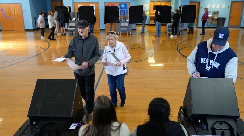 FILE - People vote at a polling site in River Edge, N.J., Nov. 4, 2025. (AP Photo/Seth Wenig, File)