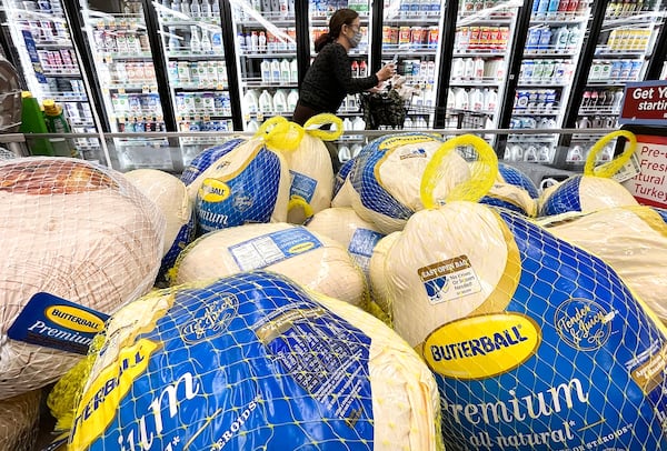 A shopper walks past turkeys displayed for sale in a grocery store ahead of the Thanksgiving holiday in Los Angeles. Grocery stores and other retailers could be discounting turkeys to lure more customers into their doors. (Mario Tama/Getty Images/TNS 2021)