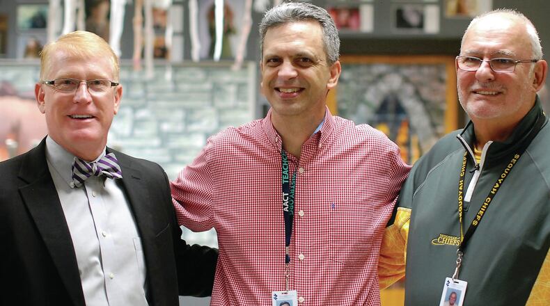 Cherokee County School District 2017 Teacher of the Year Brian Carnes, center, is congratulated by Superintendent of Schools Dr. Brian V. Hightower, left, and Sequoyah Principal Elliott Berman.