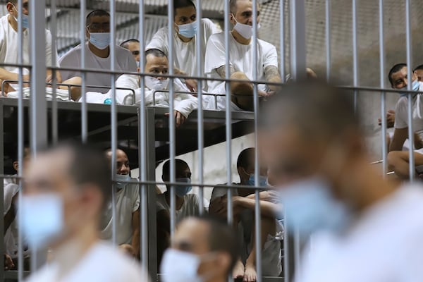 Prisoners sit in their cell as Costa Rica's Justice and Peace minister tours the Terrorist Confinement Center, in Tecoluca, El Salvador, Friday, April 4, 2025. (AP Photo/Salvador Melendez)