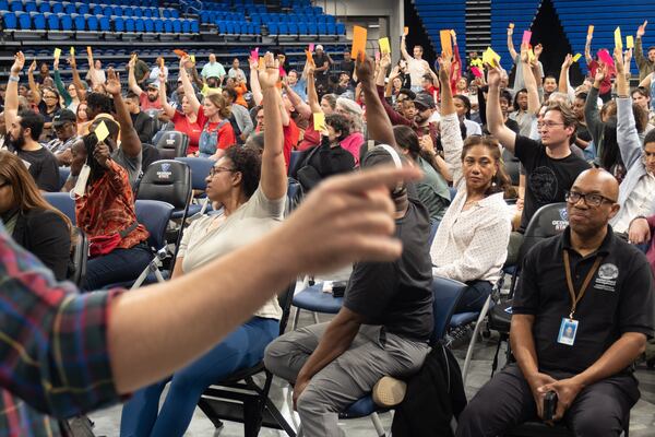 Zachary Perry, parliamentarian for NPU-V counts votes to recommend against a City of Atlanta change that would allow a data center to be built in Adair Park on Monday, April 13, 2026. (Ben Gray for the AJC)