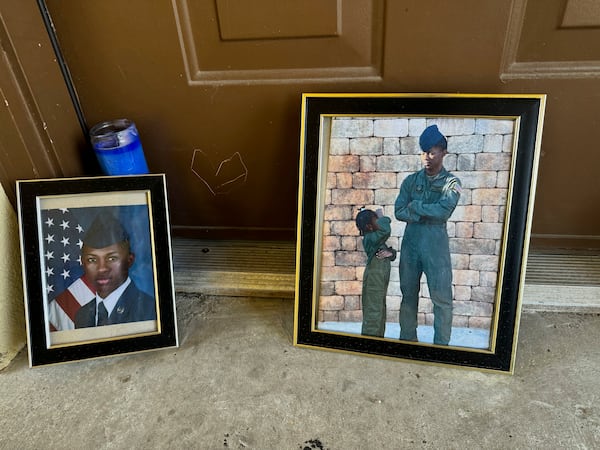 FILE - Candles and framed photos of Roger Fortson, a U.S. Air Force senior airman who was fatally shot by a Fla. sheriff's deputy on May 3, 2024, sit in the doorway of the apartment where he was killed in Fort Walton Beach, Fla., on Aug. 23. (AP Photo/Kate Payne, File)