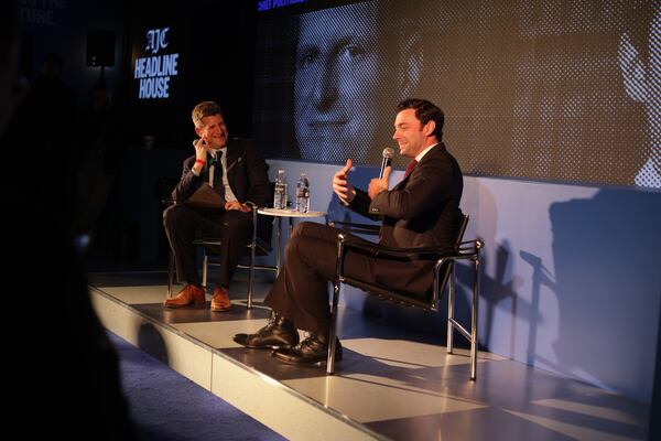 Atlanta Journal-Constitution reporter Greg Bluestein talks with Sen. Jon Ossoff at the AJC Headline House event Friday, Dec. 19, 2025. (Kitchen Table for the AJC)