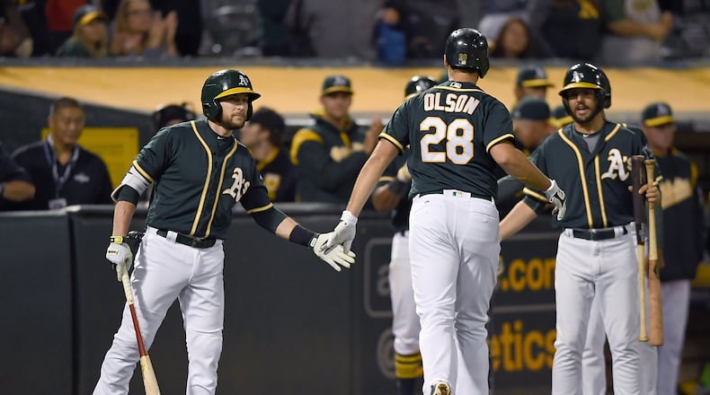 OAKLAND, CA - JUNE 30: Matt Olson #28 of the Oakland Athletics is congratulated by Jed Lowrie #8 after Olson broke up a no-hitter with a solo home run against the Atlanta Braves in the bottom of the ninth inning at Oakland Alameda Coliseum on June 30, 2017 in Oakland, California. The Braves won the game 3-1. (Photo by Thearon W. Henderson/Getty Images)