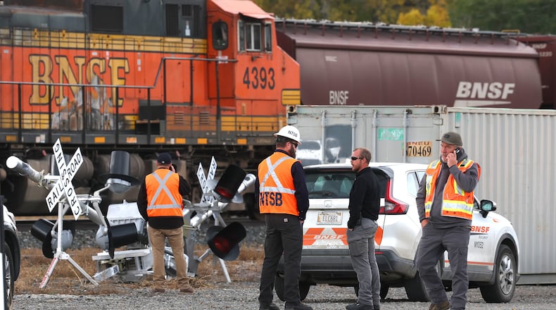 Investigators from the National Transportation Safety Board, Columbus police and Stillwater County Sheriff deputies are on the scene of an train-related accident Sunday, Oct. 19, 2025, in Columbus, MT. (Larry Mayer/The Billings Gazette via AP)