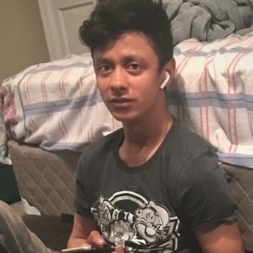 This photo provided by Henry Castro shows Josué Castro Rivera holding a cell phone in Virginia Beach, Va., in April 2021. (Henry Castro via AP)