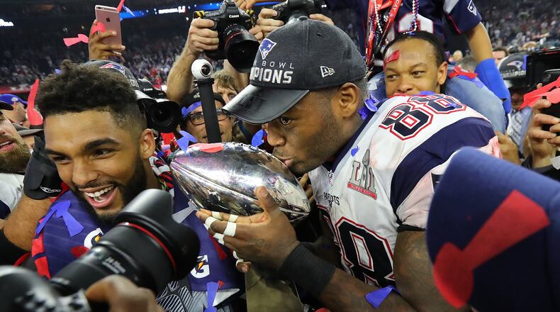 New England’s Martellus Bennett kisses the Lombardi Trophy after the Patriots beat the Falcons 34-28 in the Super Bowl. (Curtis Compton/ccompton@ajc.com)