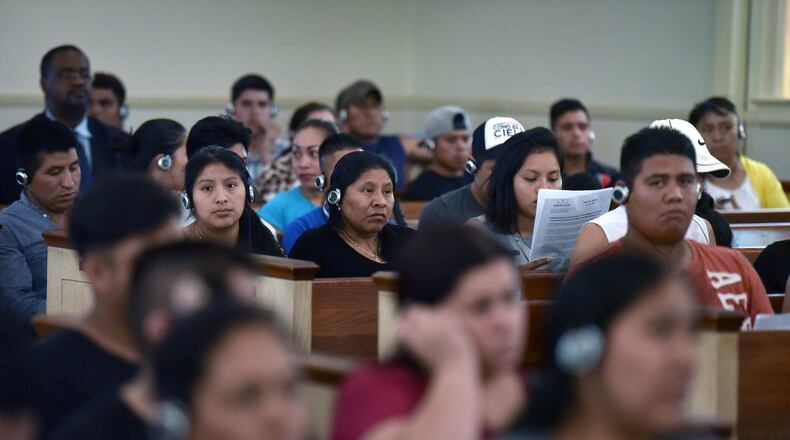 Residents of Shallowford Gardens Apartments listen to explanation of John Lantz, manger of Shallowford Gardens Apartments, through a translation system during a community meeting at First Baptist Church of Doraville on Wednesday, June 14, 2017. The DeKalb County School District late Monday approved buying that apartment complex, where it plans to build a new elementary school to alleviate overcrowding in the Cross Keys cluster of schools. Dozens of families in the 104-unit Shallowford Garden Apartments have until the end of August to find new housing. HYOSUB SHIN / HSHIN@AJC.COM